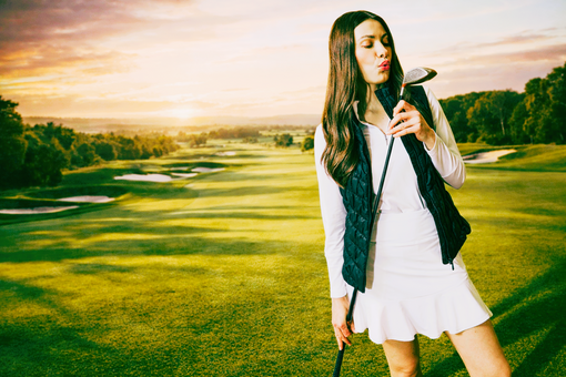 Woman golfer just after she had taken a swing on the golf course