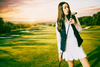 Woman golfer just after she had taken a swing on the golf course