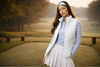 Woman golfer standing on the green wearing a white winter golf vest