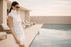 Woman wearing golf clothes with confident elegance by the pool