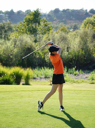 orange and black ladies’ golf outfit