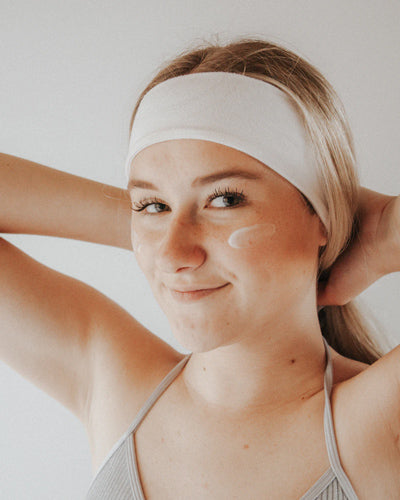 woman with moisturizer on face