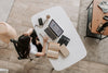 a woman working from home at a desk with a laptop