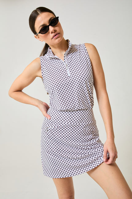Tess Ice Sleeveless Spirit, front view with sunglasses. White lattice with navy and red. Skort shown is Harlo Spirit, styling only.